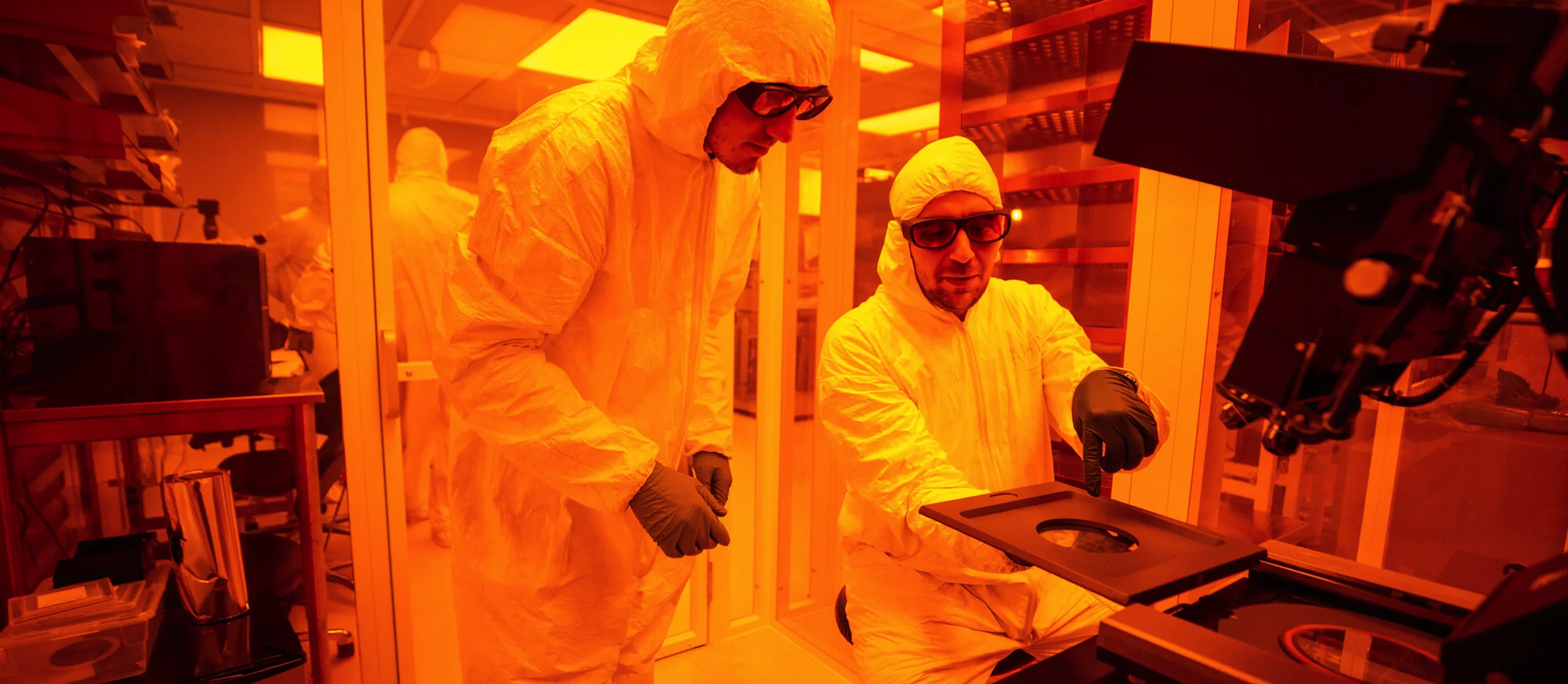 Photograph of two scientists working in a laboratory setting. 