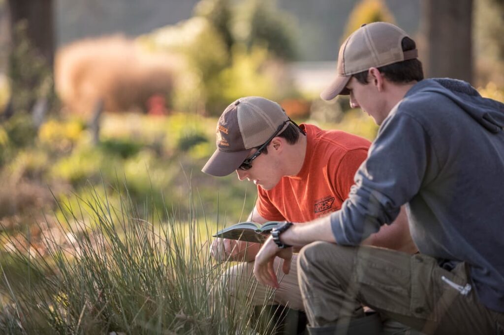 two students working in the field in nature